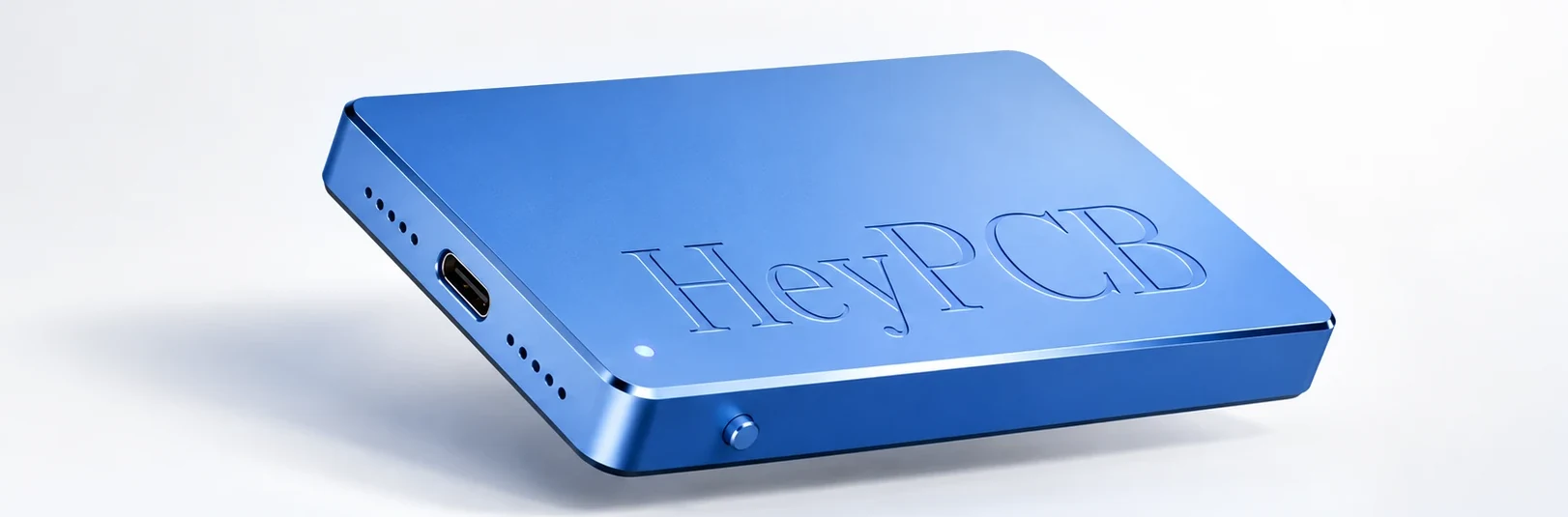 heypcb Pocket: a thin blue aluminium recorder with HeyPCB pressed into its face, a USB-C port, speaker holes, a status light and a button along its edge.